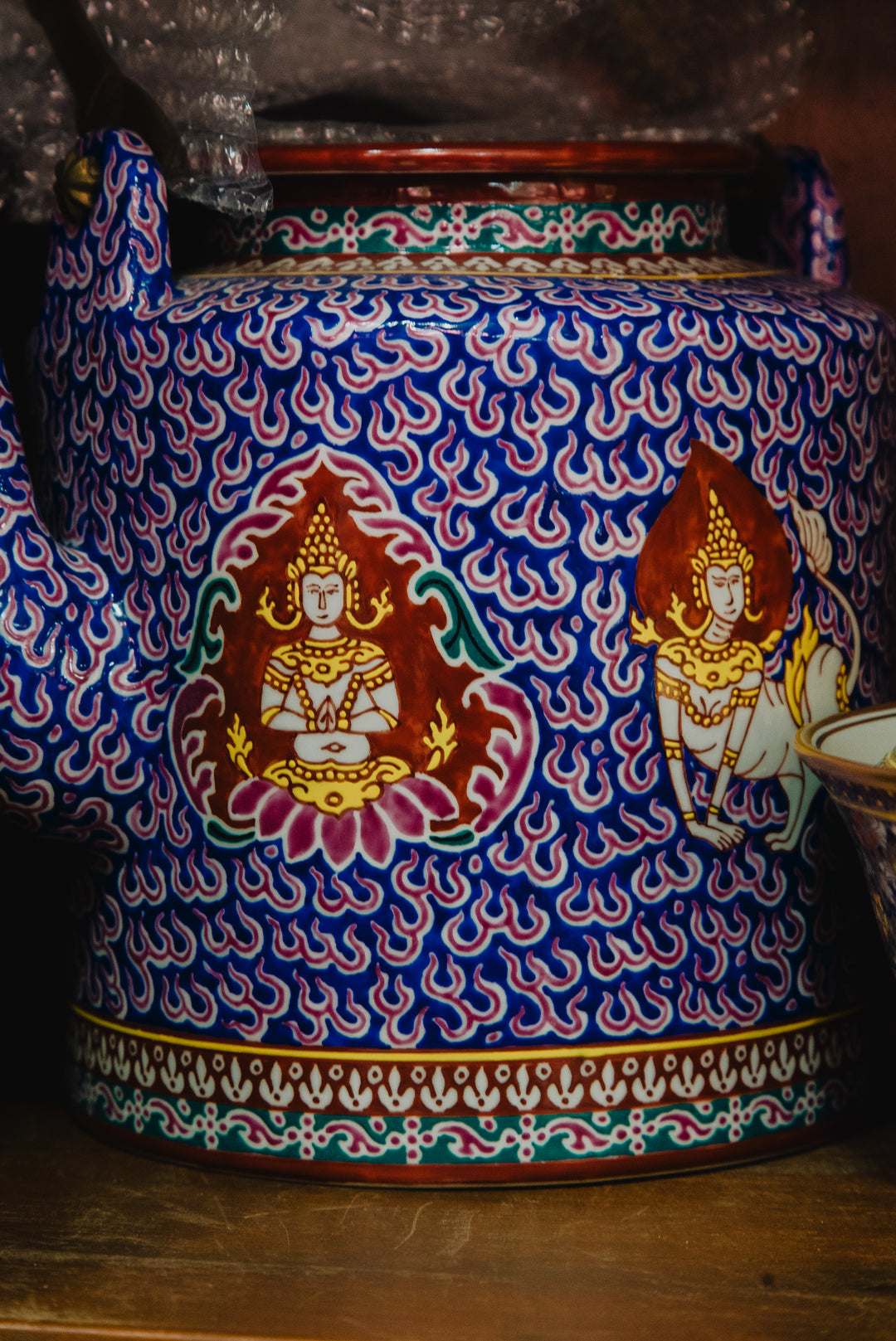 Detail of a Pinsuwan Benjarong vessel showing raised gold enamel and layered floral motifs